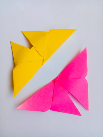 Origami birds in yellow and pink. Origami birds isolated on white background.の写真素材