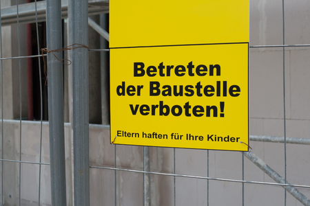 German sign that says No trespassing the construction site. Parents responsible for their children, copyspace for textの写真素材