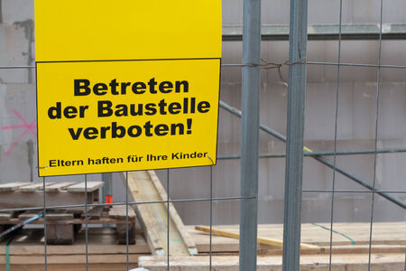 German sign that says No trespassing the construction site. Parents responsible for their children, copyspace for textの写真素材