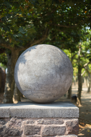 A ball made of stone on a wallの写真素材