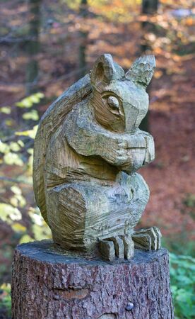 A carved squirrel on a tree stumpの写真素材