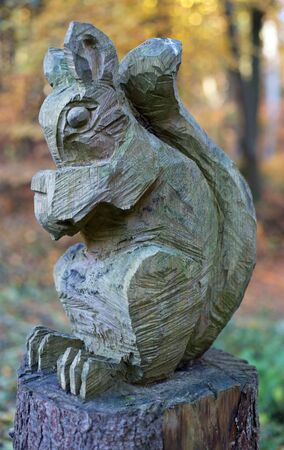 A carved squirrel on a tree stumpの写真素材