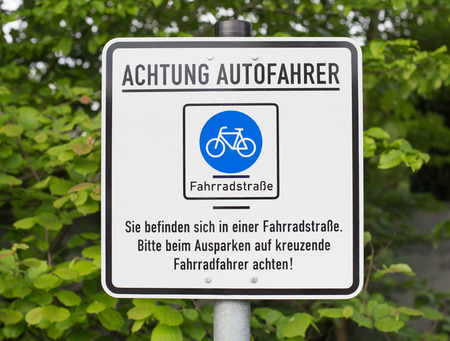 German sign that says: Attention car drivers. You are in a bicycle road. Pay attention to cyclists.