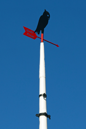 Ship mast with stylized bird and wind flag and the german words for Good Tripの写真素材