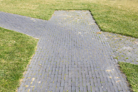 Right or left or straight on. A fork in the road in a parkの写真素材