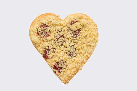 Streusel or crumble heart with jam, isolated on whiteの写真素材