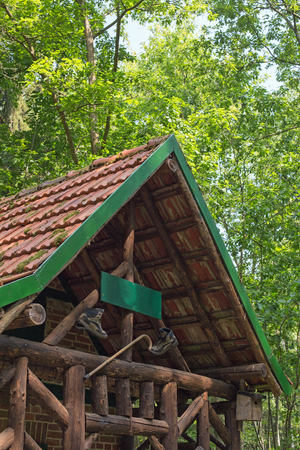 A wooden cabin with walking boots and walking stick in a forestの写真素材
