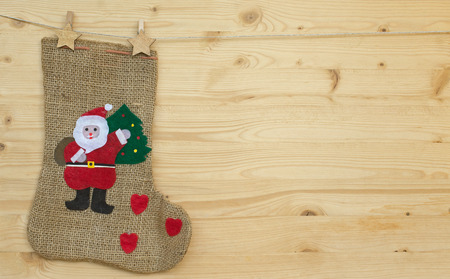 santa claus sock or stocking with clothes pegs on woodの写真素材