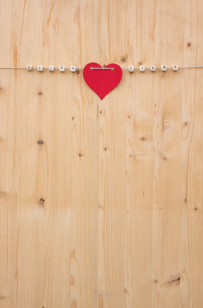 The german words for all love and a heart on a cord on woodの写真素材