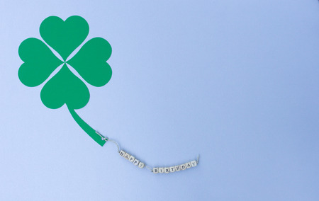 The words Happy Birthday on a cord and a cloverleafの写真素材