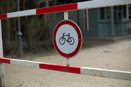 German metal sign on a barrier which means bicycles forbiddenの写真素材