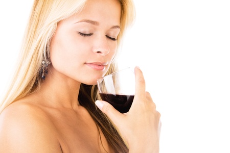 Closeup studio portrait of a beautiful young woman with a glass of red wine, isolated on white backgroundの写真素材