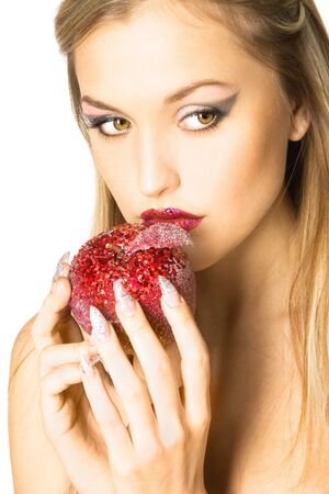 Closeup studio portrait of beautiful sexy young woman with red apple, isolated on white backgroundの写真素材