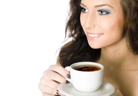 Beautiful young girl with a cup of hot coffee drink, isolated on white backgroundの写真素材