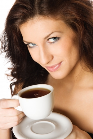 Beautiful young girl with a cup of hot coffee drink, isolated on white backgroundの写真素材