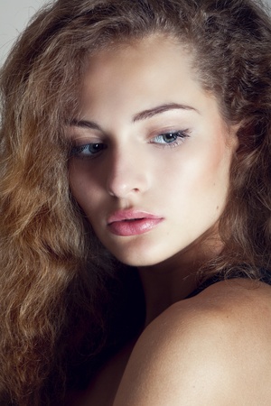 Beautiful sexy young woman with curly hairの写真素材
