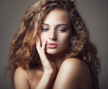 Beautiful sexy young woman with curly hairの写真素材