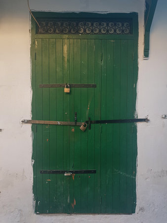 Explore the old door in the city of Tetouan. Step into a bygone era as you traverse the narrow, winding streets of the medina and unlock the secrets of this hidden gem. Immerse yourself in the rich history, vibrant culture, and stunning architecture that define Tetouan. From ornate doorways to intricate mosaics, every step reveals a tale waiting to be discovered. Engage with friendly locals, sample authentic Moroccan cuisine, and capture breathtaking views of the city from ancient vantage points.の写真素材