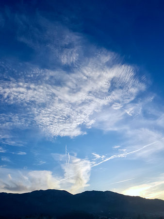 Celestial Canvas Where Sunbeams Kiss the Clouds, The skyscape in a symphony of sunset as the sun...