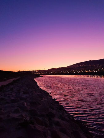 The vibrant colors reflection on river in bottom of the city after the sun disappeared