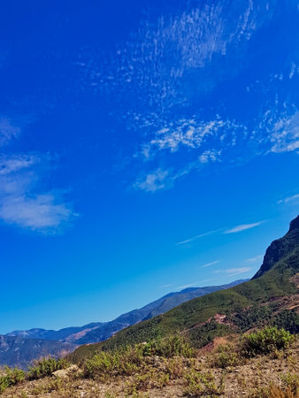 Nature in rugged mountains stretching into the distance under a clear blue sky. This captivating...