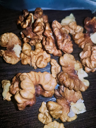 A detailed close-up of the walnut kernel elegantly exposes its interior, showcasing the freshly revealed, nutrient-rich core alongside its distinctive texture.の写真素材
