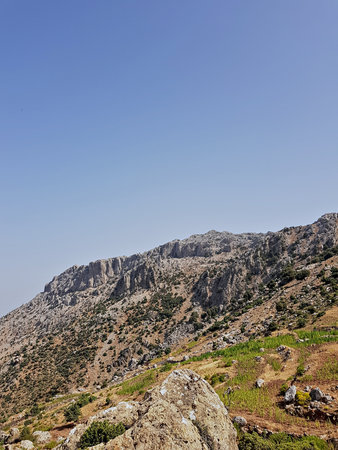 A breathtaking mountain scene. rugged rocky slopes and jagged ridgelines rise to towering peaks...