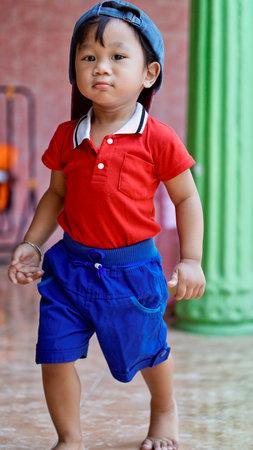 little boy wearing a backwards hat, cute behavior of children exploring activities