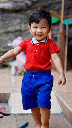 the happiness of a boy, walking with a smile facing the camera