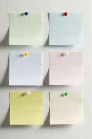 Blank paper, hanging on the wall with a colored pushpin