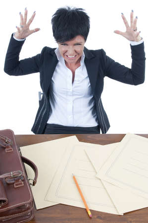 Stressed businesswoman sitting at her deskの写真素材