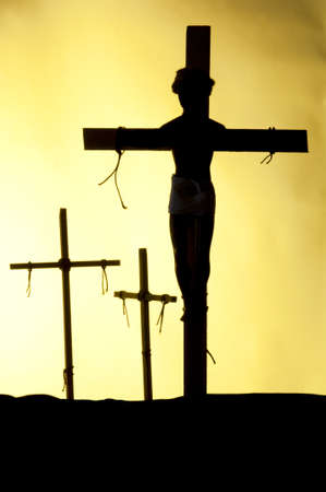 Shadow and silhouette of the crucifixion on a yellow background