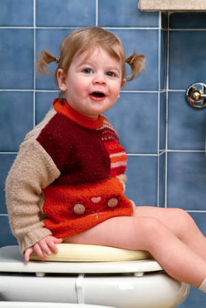 Little girl on the toilet that makes funny faces