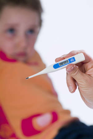 Sick child measures the fever with a digital thermometer