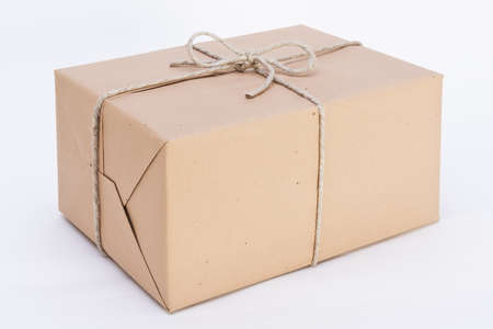 package ready for shipment, wrapped in brown paper and tied with twineの写真素材