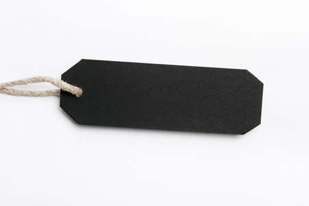 Black tag with hemp thread bound to the holeの写真素材