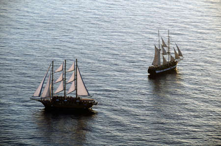 Sailing ships in the bay of Santorini Greeceの写真素材