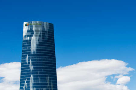 Bilbao, Spain - March 26, 2016: Iberdrola Tower, In front of a blue sky and white cloudsのeditorial素材