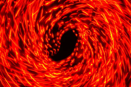 Trails of blurry red radial lights on a black background, can use background