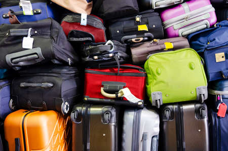 Suitcases multicolor stacked ready for transport one above the otherの写真素材
