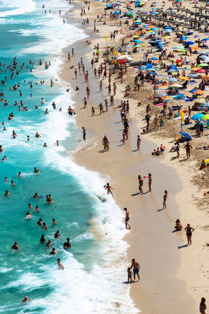 Mallorca, Spain, August 16, 2019: view from the top, of the beach and shoreline crowded with tourists and umbrellasのeditorial素材