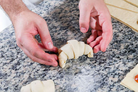 Stages of preparation, pastry chef prepares jam croissant in pastry shopの写真素材