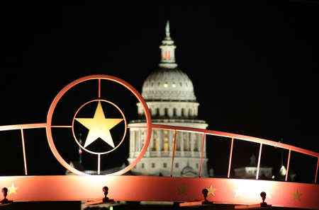 A shot of the star of Texas with the Texas State Capitol Building in the background.の写真素材