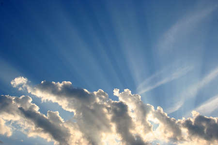 The sun shining out from behind the clouds.