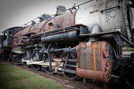 an old steam train at a train depot の写真素材