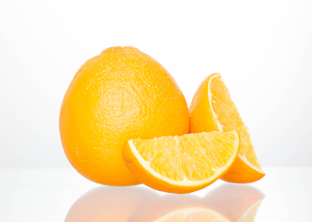 oranges on glass and white background