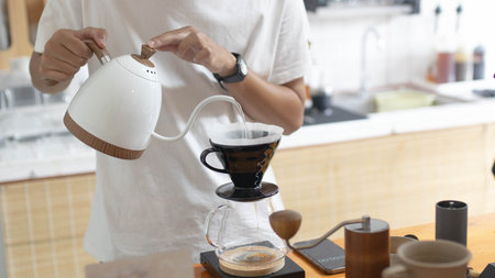 Barista is making drip brewing, filtered coffee, or pour over coffee with hot water and filter paper in coffee shop and drip kettle alternatives to coffee shop concept coffee.の写真素材
