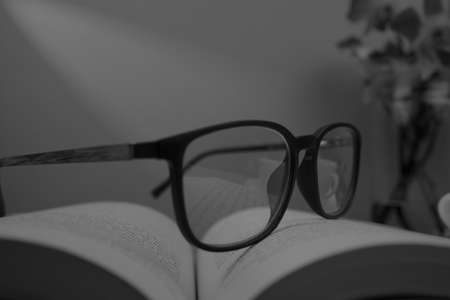 The eyeglasses are placed on the opened book.の写真素材