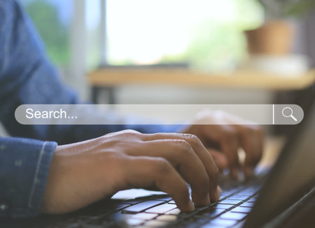 Data Search Technology Search Engine Optimization Man's hand finger typing on laptop keyboard to search data and information.の写真素材