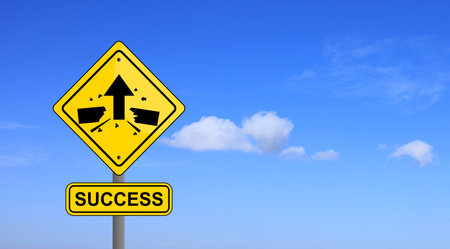 A yellow sign success with arrows pointing upwards telling them to break through and hit any obstacles against a blue sky background is a sign of encouragement to people who are striving for success.の写真素材